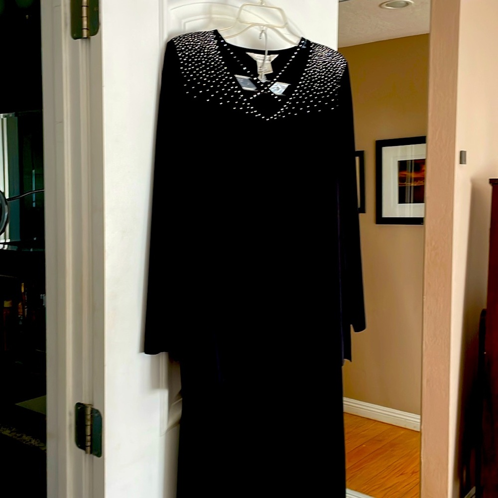 Black top with rhinestones and a black midi matching skirt.